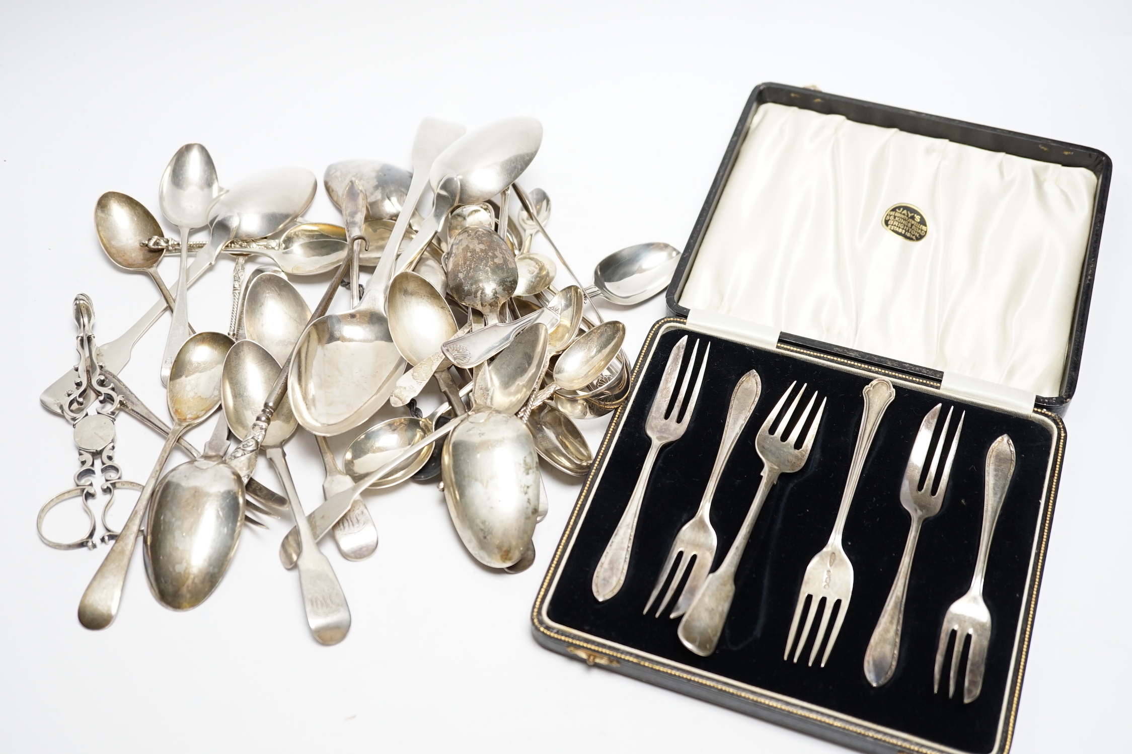 A quantity of assorted 19th century and later silver flatware, various dates, patterns and makers including a pair Georgian sugar nips, 30.2oz.